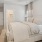 a bedroom with a bed and lamps